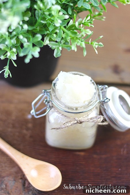 Homemade Lavender and Vanilla Sugar Scrub for Silky Skin 6 Lavender Vanilla Sugar Scrub sitting in a bottle with the lid open and a spoon next to it.