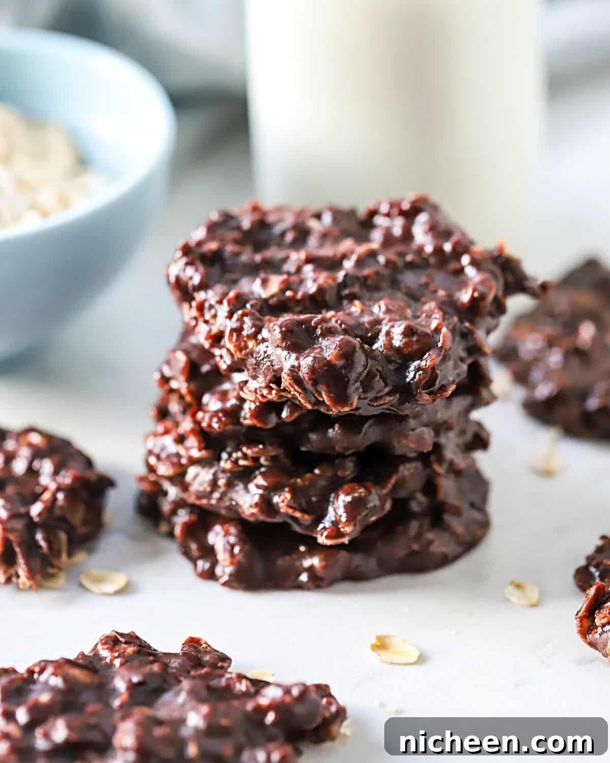 Quick No-Bake Chocolate Peanut Butter Cookies 2 A stack of four no-bake peanut butter chocolate cookies.