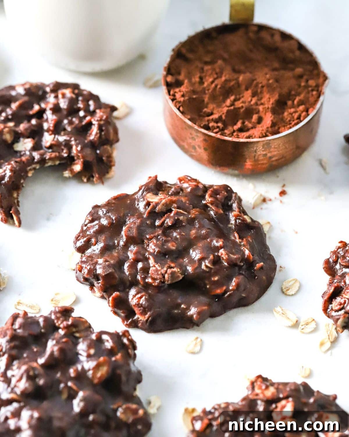 Quick No-Bake Chocolate Peanut Butter Cookies 6 Chocolate no-bake cookies on a counter top.