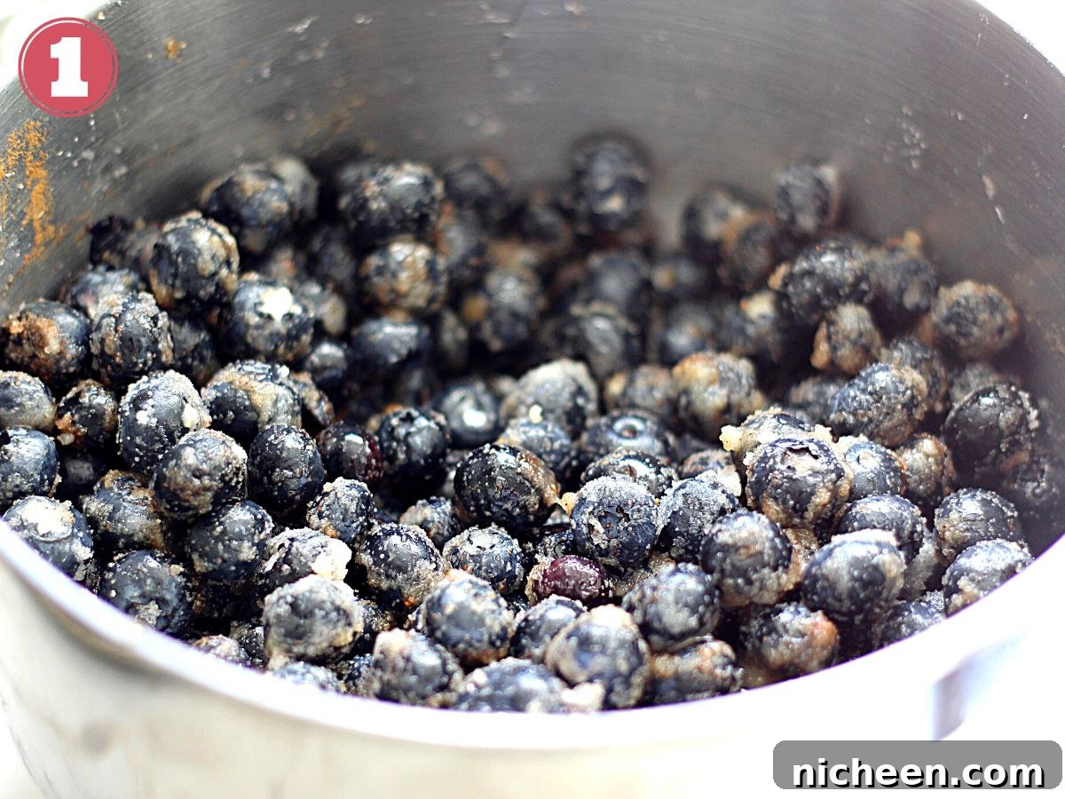 Blueberry Cobbler with Cookie Dough Crust Recipe 4 Bowl filled with blueberries, sugar, and lemon juice.