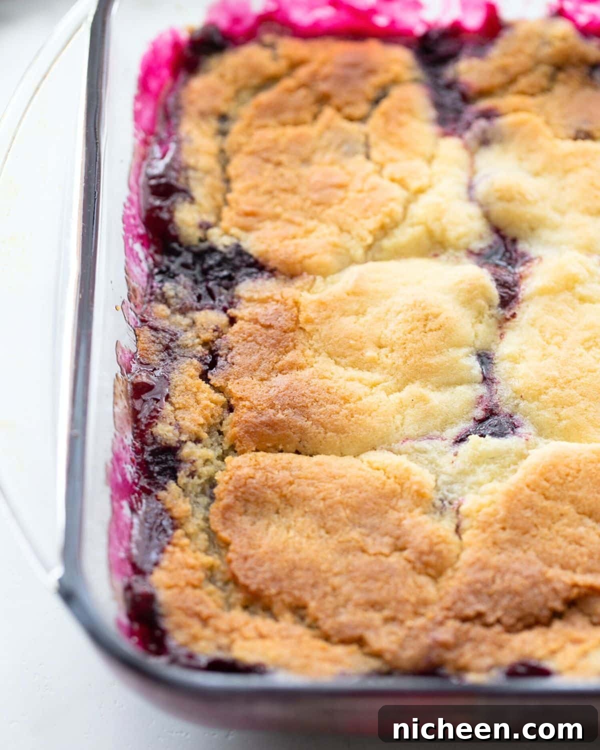 Blueberry Cobbler with Cookie Dough Crust Recipe 6 Square baking dish with fruit cobbler inside.