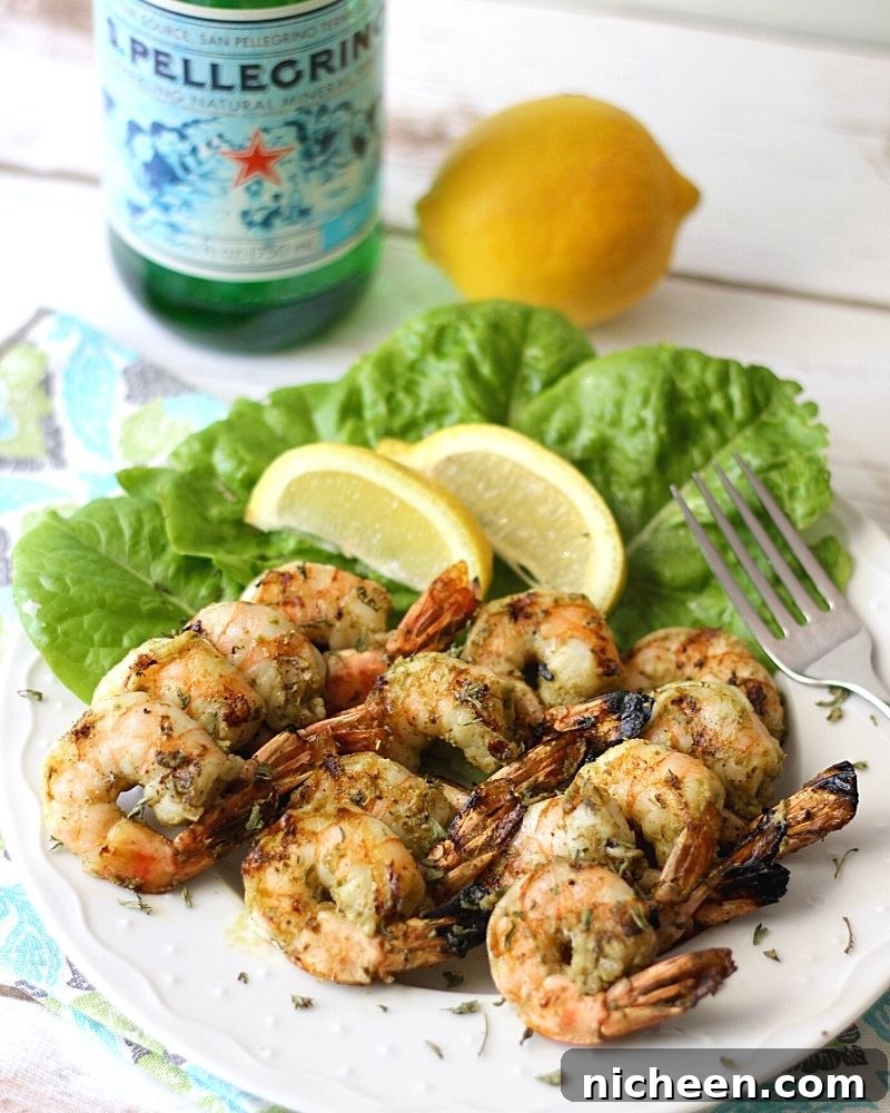 Grilled shrimp on a plate with lemon wedges