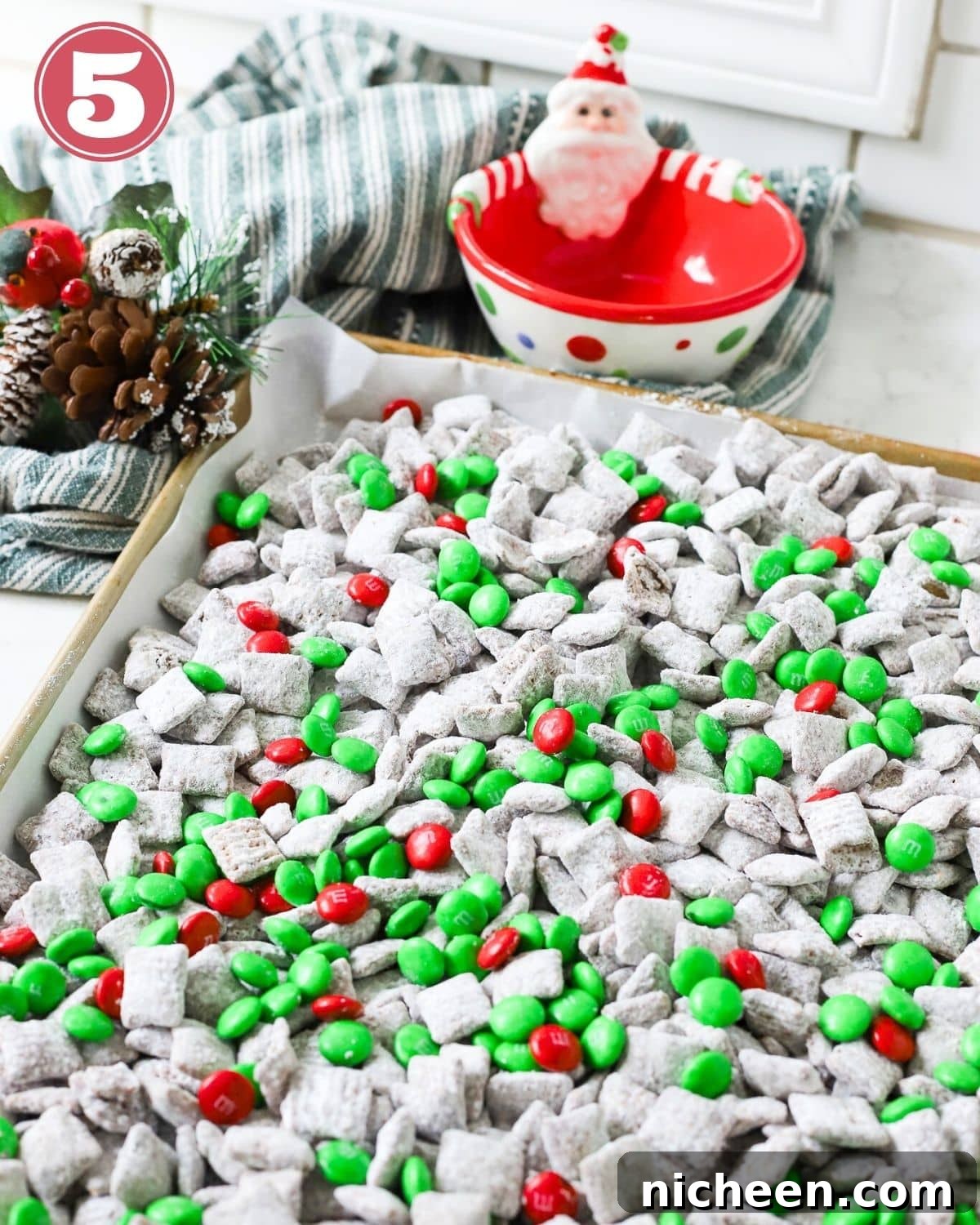 A tray of Christmas puppy chow with green and red M&Ms.
