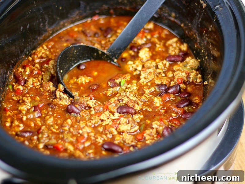 Turkey Chili in a crockpot with a ladle.