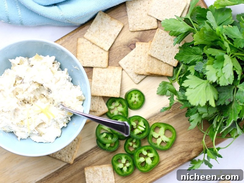 Crispy Jalapeno Popper Toppers Recipe 5 Jalapeno Popper Topper ingredients on a cutting board with crackers.