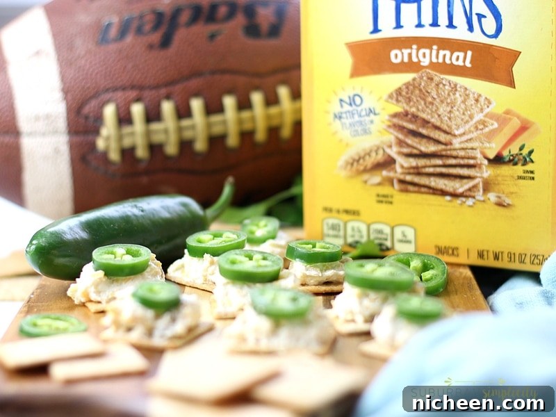 Crispy Jalapeno Popper Toppers Recipe 6 Wheat Thins with a cheesy dip topped with a jalapeño pepper.