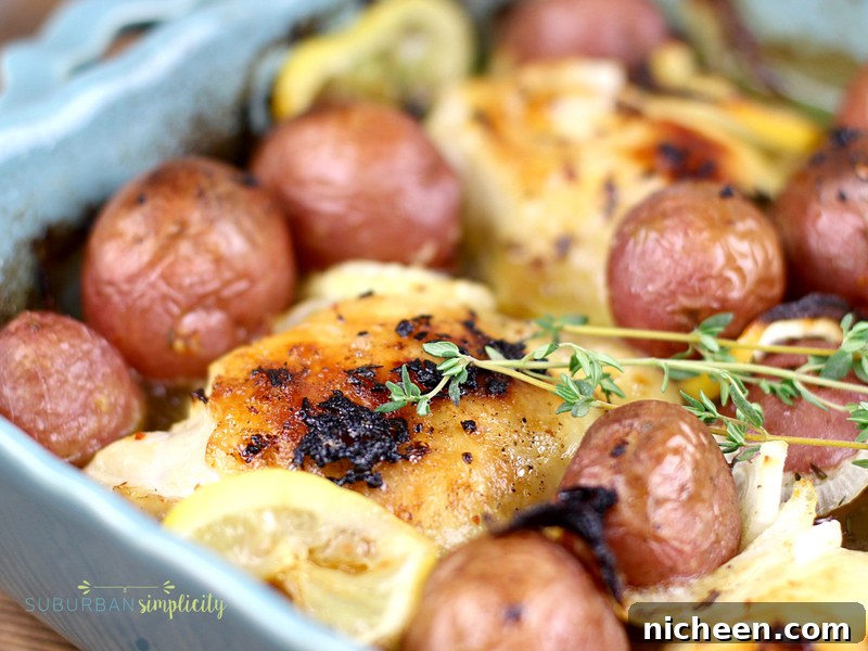 Oven-Baked Lemon Chicken Recipe: Crispy, Tender 2 Baked lemon chicken in a blue baking dish with fresh thyme.