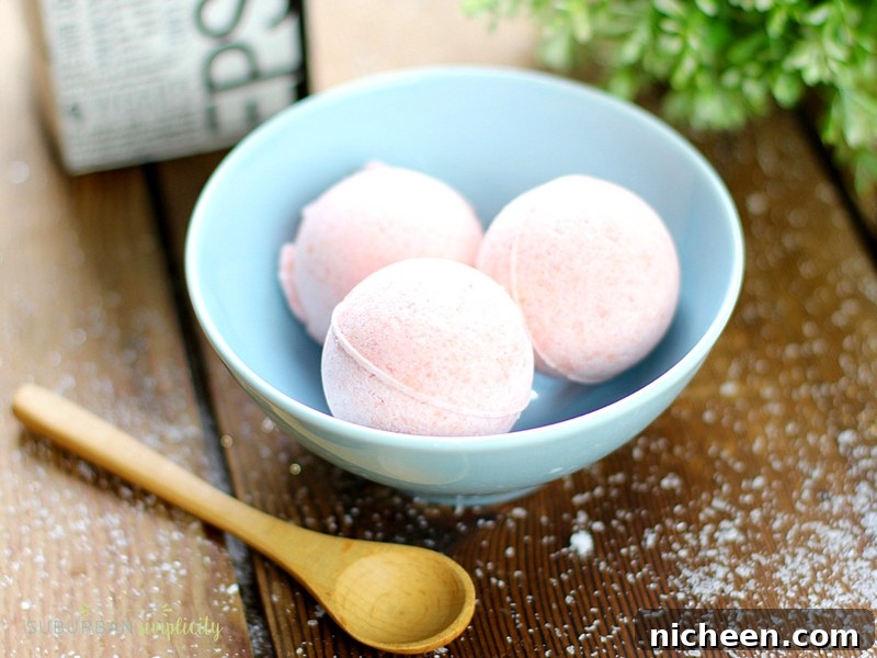 Easy DIY Bath Bombs in a blue bowl with a spoon next to it.
