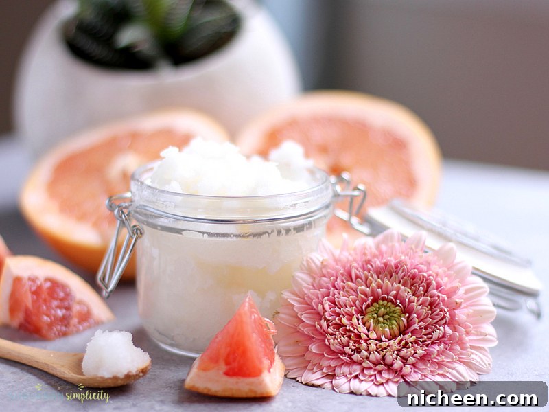 DIY Grapefruit Sugar Scrub Recipe for Radiant Skin 4 Jar of grapefruit sugar scrub with a spoon of scrub next to it.