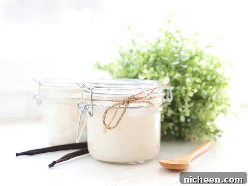 Homemade Vanilla Sugar Scrub and Free Printable Labels 2 Jar of DIY vanilla sugar scrub with a spoon and vanilla bean next to it.