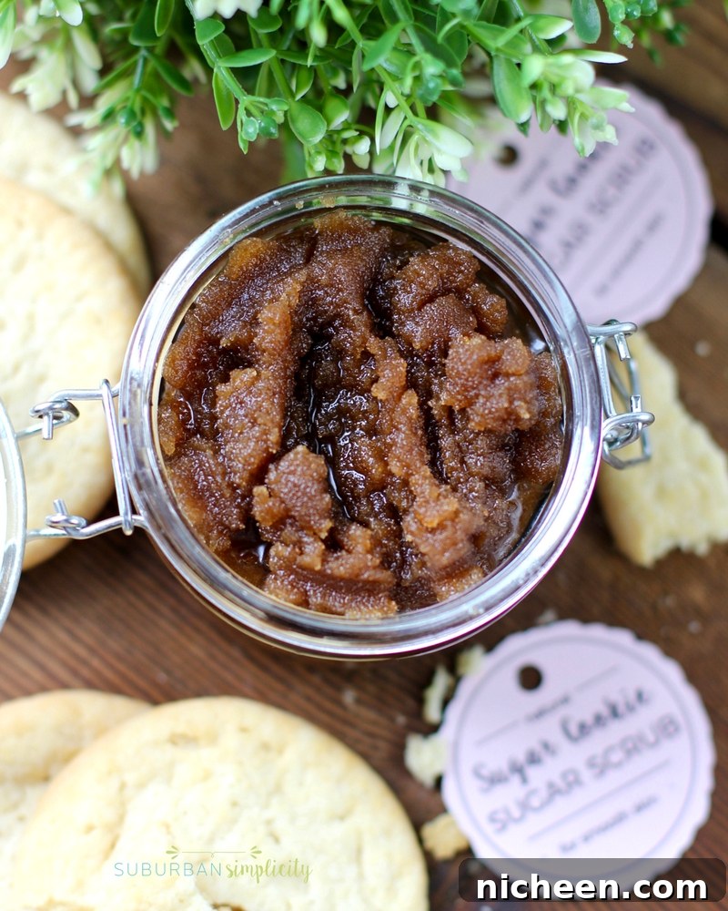 23 Homemade Sugar Scrub Recipes for Glowing Skin 2 Top down view of Sugar Cookie Sugar Scrub in a jar with tag scattered around.