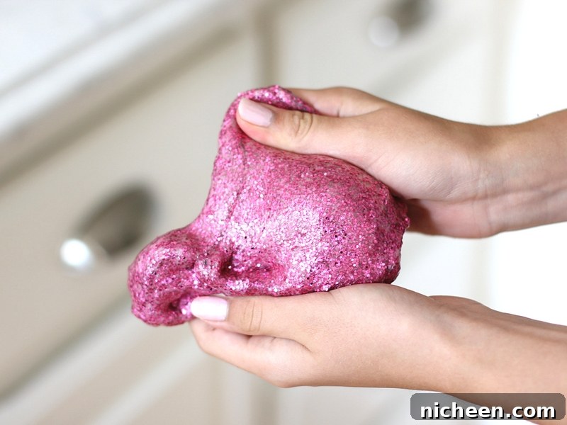 25 Summer Activities Tweens Will Love 3 Pink glitter slime in a girl's hands.