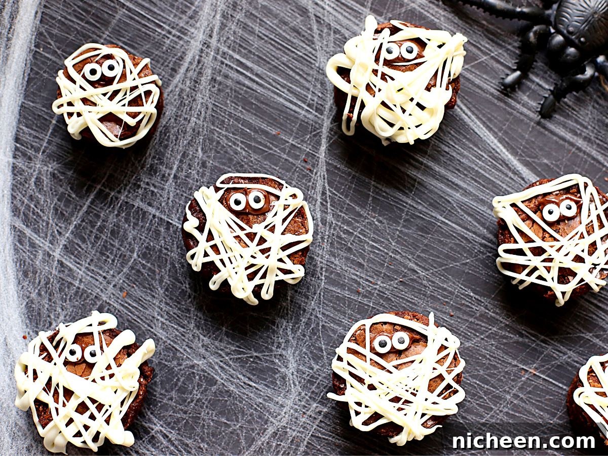 Halloween Mummy Brownies Recipe: Creepy Wrapped Treats 4 Mummy brownies on a spider web.