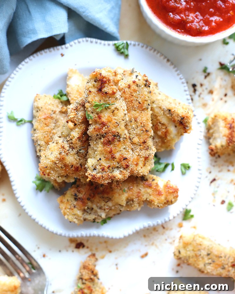 Chicken tenders with herbs on top.