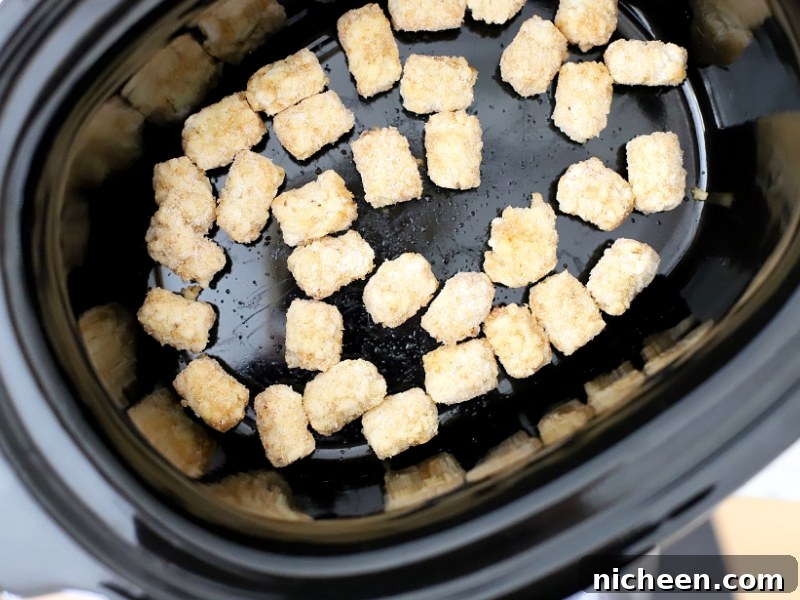 Slow Cooker Tater Tot Casserole 6 Tater tots in the bottom of a crock pot.