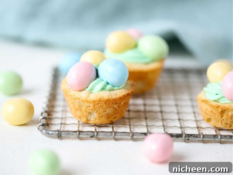 Three Easter Cookie Cups with candy on top.