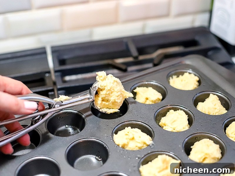 Muffin tin filled with Easter Cookie Cup batter.
