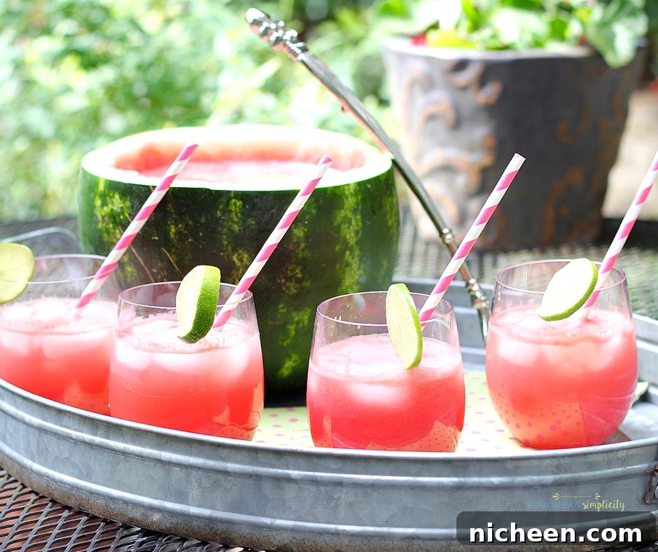 Watermelon Punch with stripped straws in a serving tray