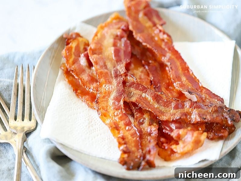 How to Cook Bacon in the Oven for Crispy, Evenly Cooked Strips 3 Cooked bacon on a plate.