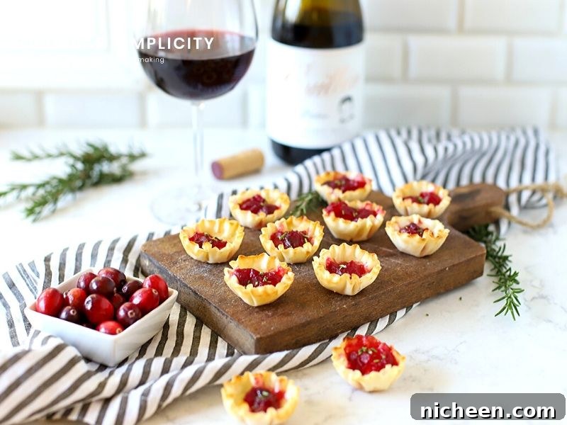 Cranberry Brie Bites are a deliciously easy way to entertain guests! With only 3-ingredients you have a wonderful bite-sized appetizer to serve at your next party!