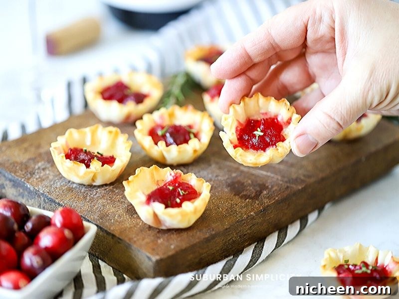 A mini cranberry brie bite on a serving tray