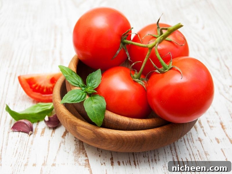 Meal Prep and Quick Cooking Tips for Busy Moms 5 A wooden bowl filled with fresh tomatoes on a counter.