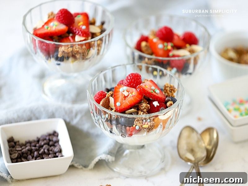 Yogurt sundae in a bowl with spoons next to it