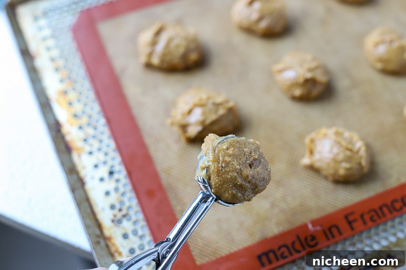 40 Baking Tips That Transform Cakes, Cookies and Bread 5 scooping gf peanut butter cookie batter onto cookie sheet