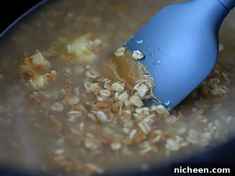 Creamy Slow Cooker Peanut Butter Oatmeal 3 Ingredients in crockpot for oatmeal with peanut butter