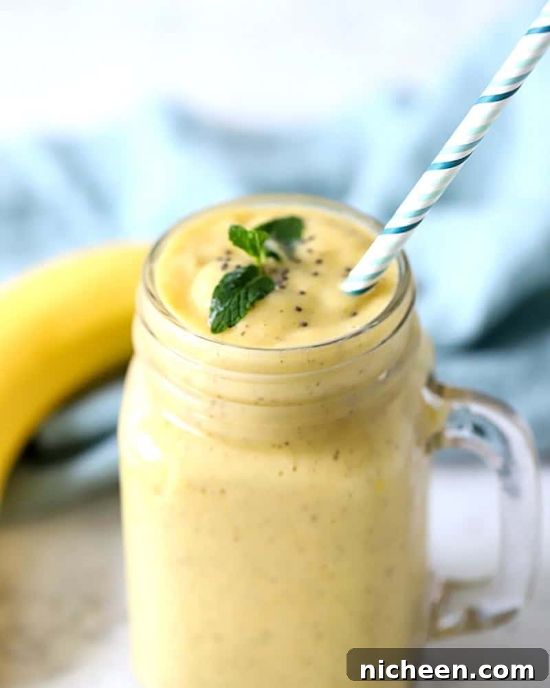 Tropical Mango Pineapple Smoothie Recipe 6 smoothie in a cup with a straw