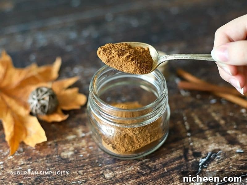 Homemade Pumpkin Pie Spice Recipe 4 pumpkin spice mix being put into a jar
