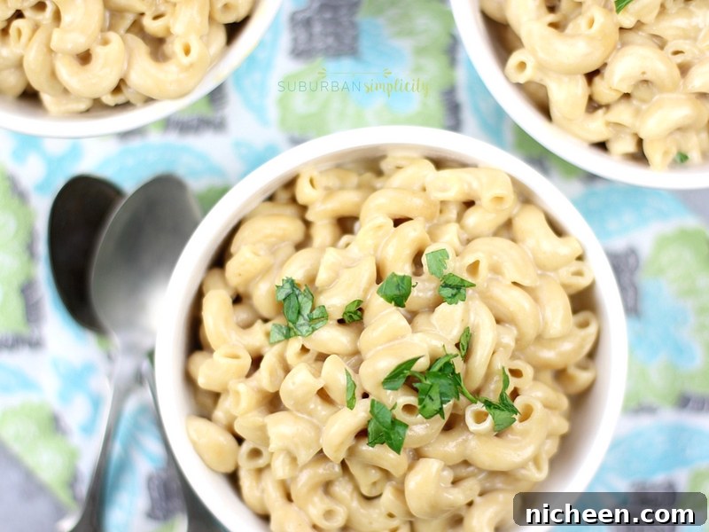macaroni and cheese made in the instant pot in a bowl with garnish on top.
