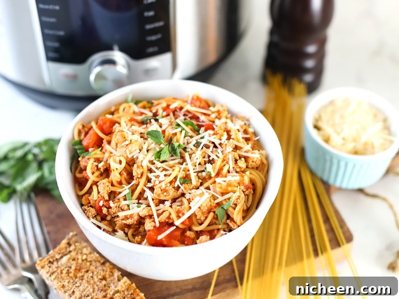 Instant Pot Spaghetti in a bowl with garlic bread.