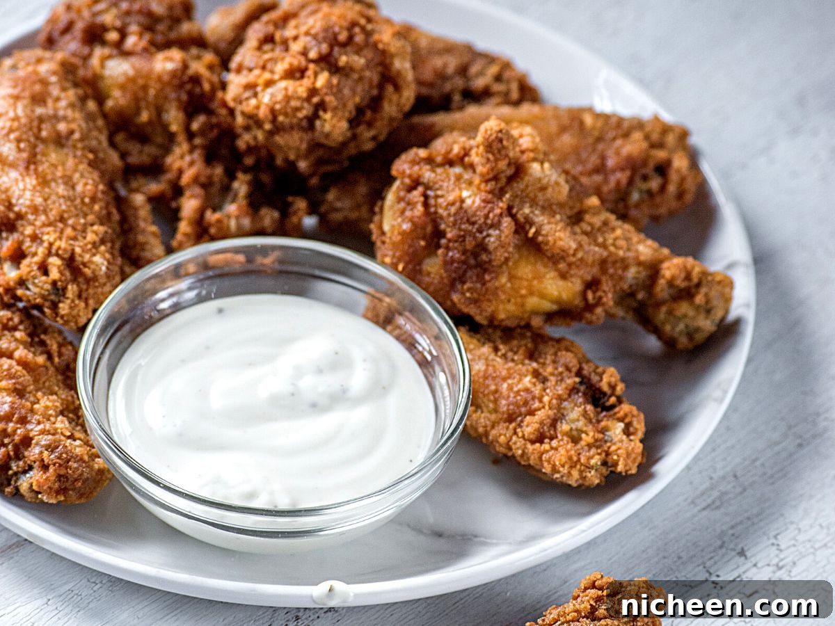 15 Irresistible Dipping Sauce Recipes for Chicken Tenders 4 chicken fingers with ranch dipping sauce on a plate.
