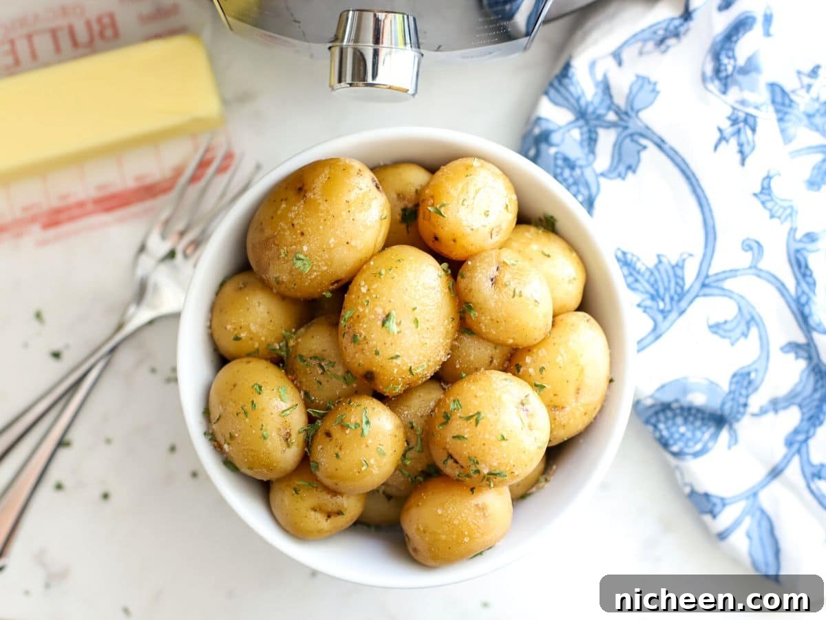 Instant Pot Baby Potatoes with Garlic and Herbs 7 Steamed potatoes in a bowl with butter.