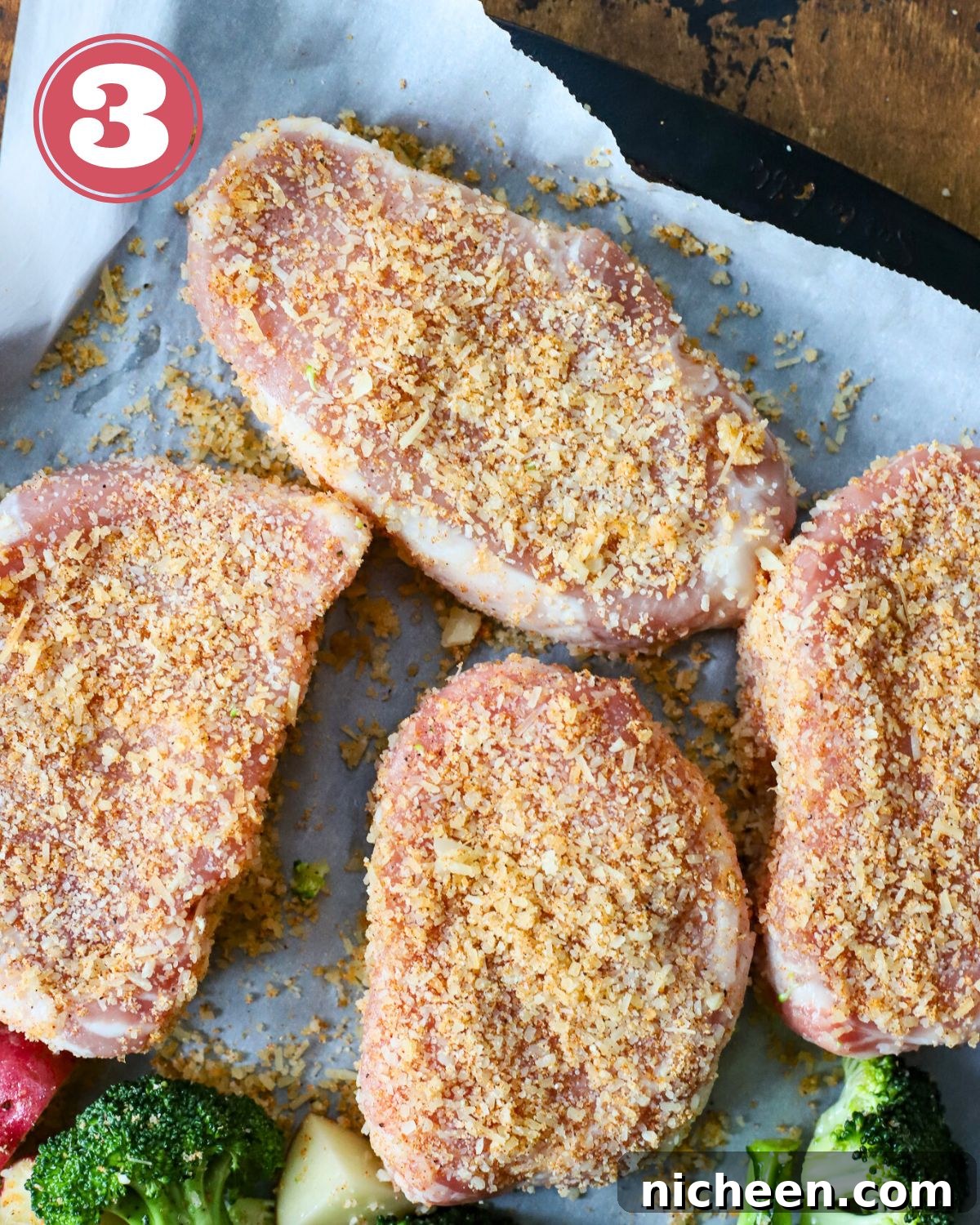One-Pan Pork Chops with Crispy Potatoes 6 Four pork chops with a Parmesan rub on them.