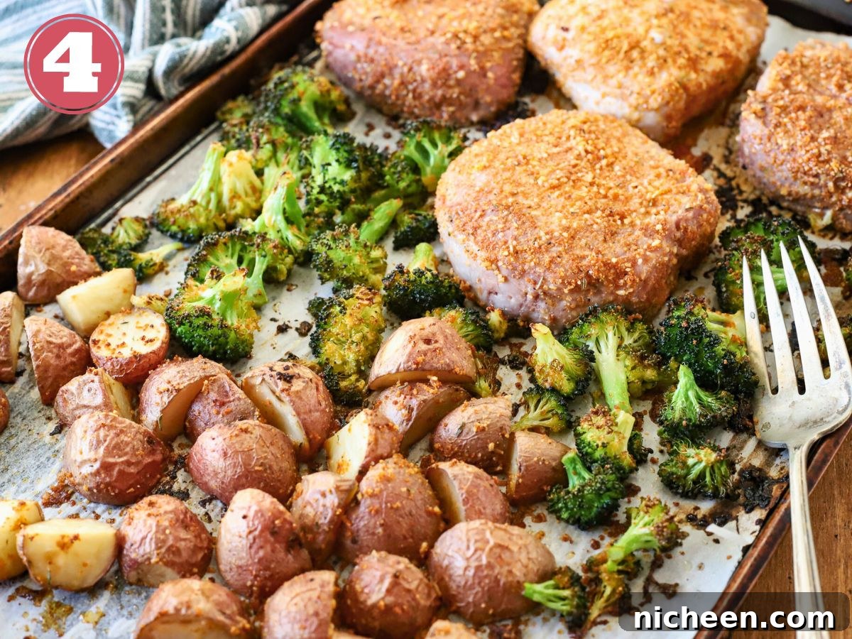One-Pan Pork Chops with Crispy Potatoes 7 A sheet pan full of baked pork chops, potatoes, and broccoli.