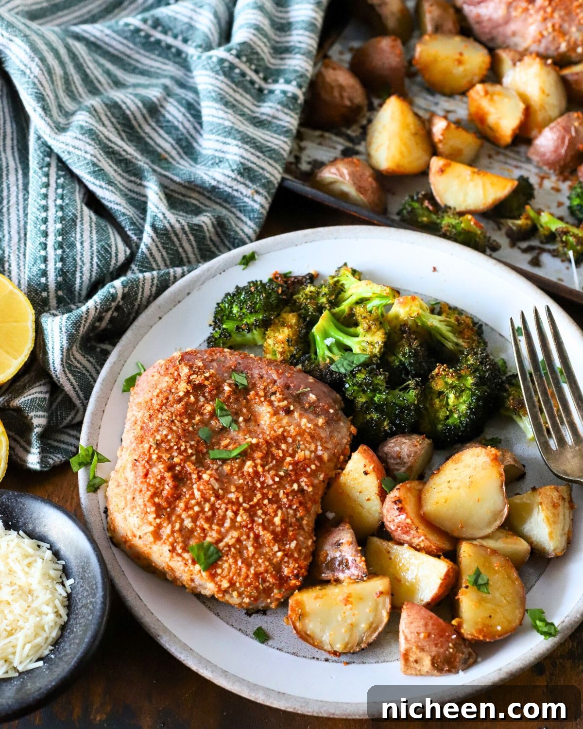 One-Pan Pork Chops with Crispy Potatoes 8 A plate with one-pan pork chops and veggies.