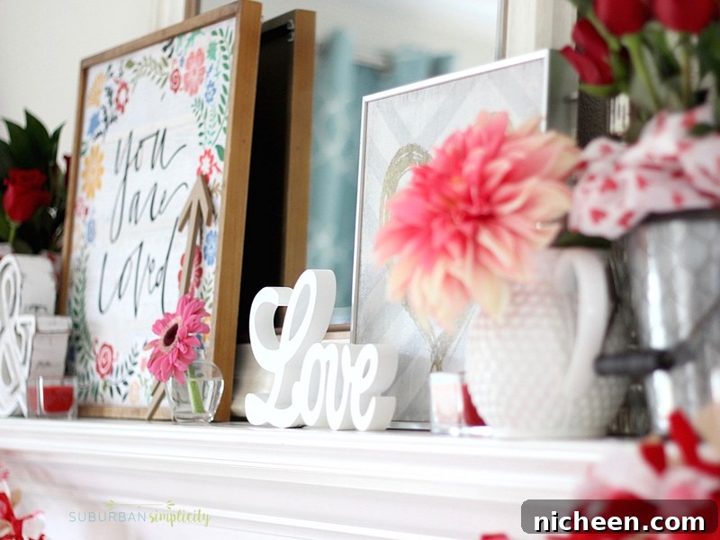 Farmhouse buckets filled with red roses on a mantel