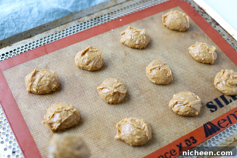 Flourless peanut butter cookie batter on a baking sheet.
