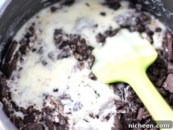 Mini Oreo Cheesecakes Recipe 3 Ingredients for Oreo Cheesecakes being stirred around.