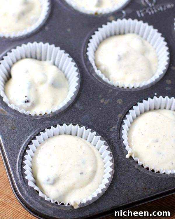 Mini Oreo Cheesecakes Recipe 4 Muffin tin filled with Oreo Cheesecake batter.