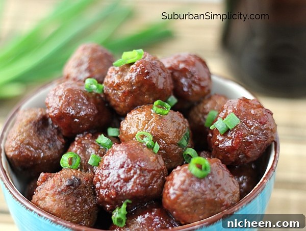 Crockpot meatballs in a bowl with fresh green onion slices on top.