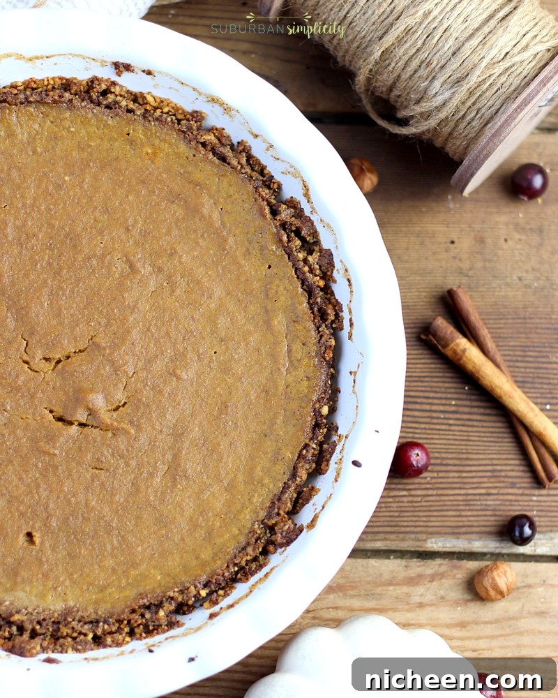 This Paleo Pumpkin Pie tastes delicious and is grain and dairy free. This healthier Thanksgiving recipe has just the right amount of spice and a velvety filling you'll crave all season long!